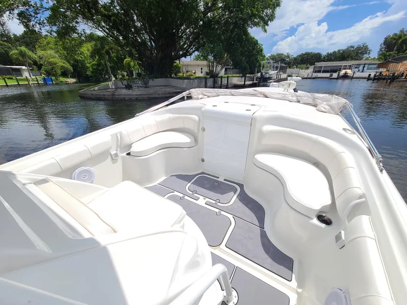 Slide: The Image of 2009 Glasstream 360 SCX boat interior with white seating and scenic waterway background. - 17