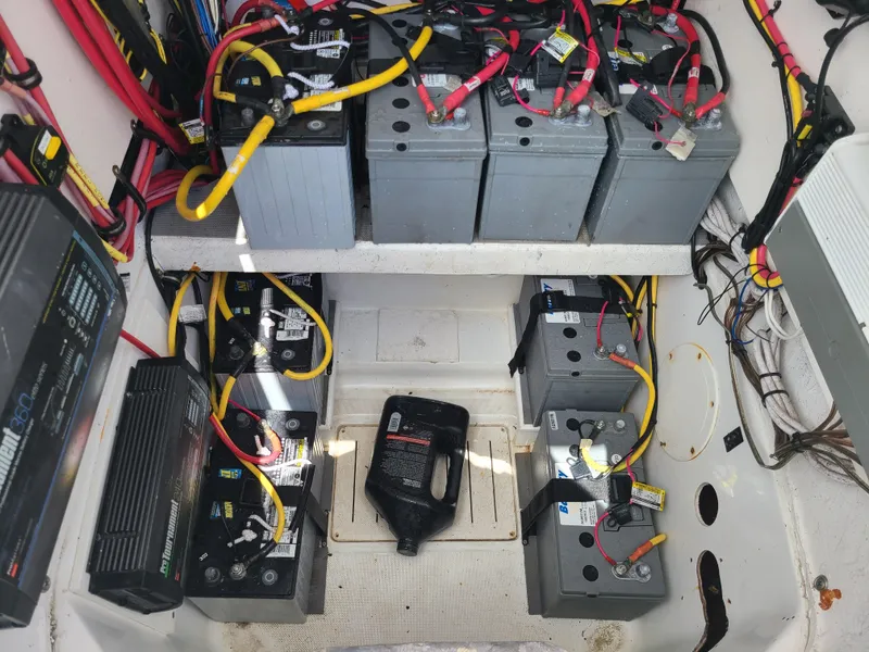 Slide: The Image of Battery compartment of a 2009 Glasstream 360 SCX boat with multiple batteries and wiring. - 19