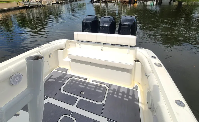 Slide: The Image of 2009 Glasstream 360 SCX boat with triple outboard engines docked on calm water. - 28