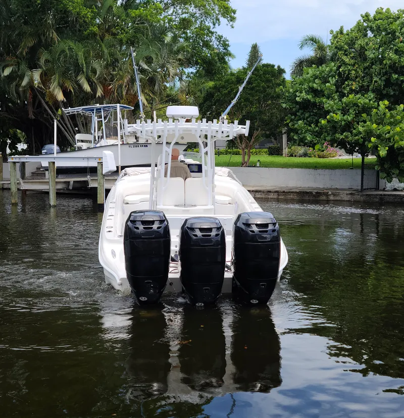 Slide: The Image of 2009 Glasstream 360 SCX boat with triple outboard motors on a calm waterway. - 29