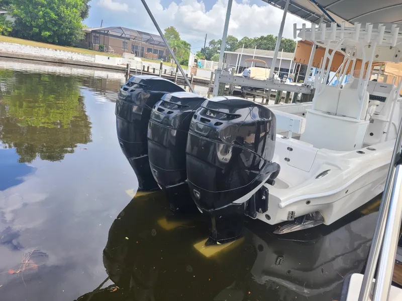 Slide: The Image of 2009 Glasstream 360 SCX boat with triple outboard motors docked in a marina. - 31