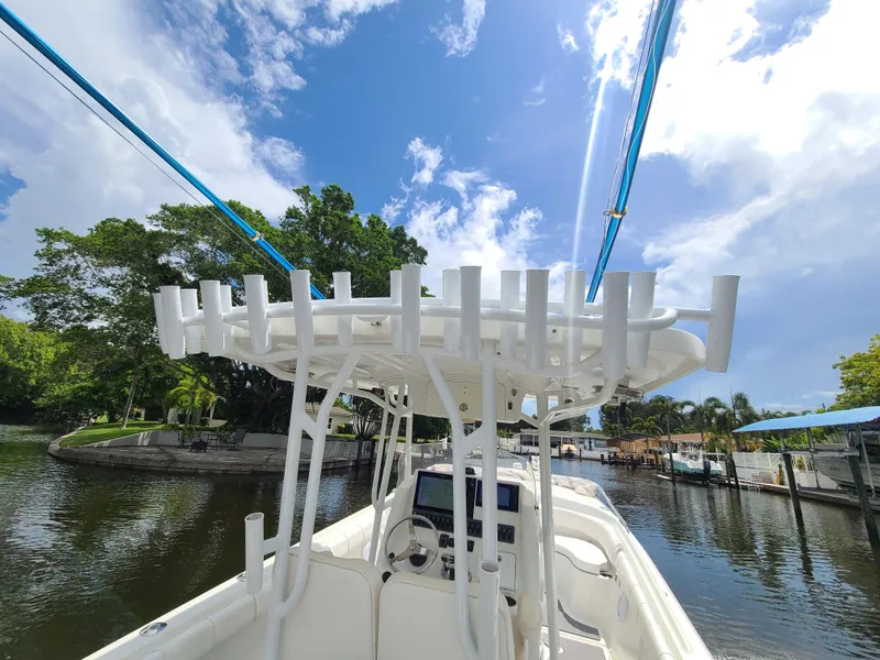 Slide: The Image of 2009 Glasstream 360 SCX boat on a sunny day, docked by a lush riverside. - 9
