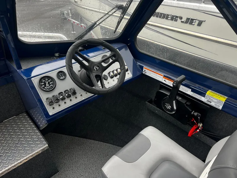 Slide: The Image of 2024 Thunder Jet 200 Luxor boat interior, featuring steering wheel and control panel. - 10
