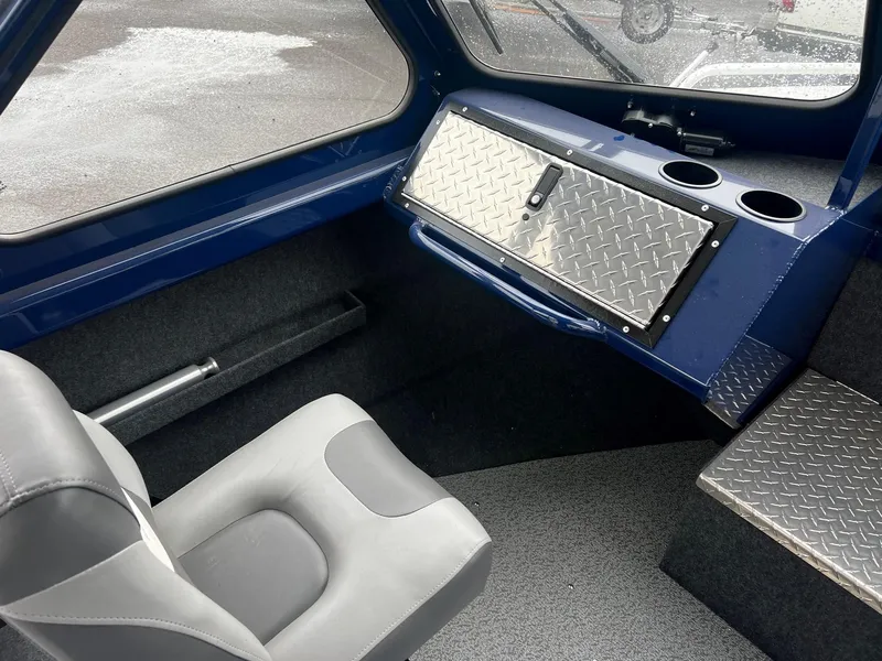 Slide: The Image of 2024 Thunder Jet 200 Luxor boat interior with gray seat and diamond plate storage. - 11