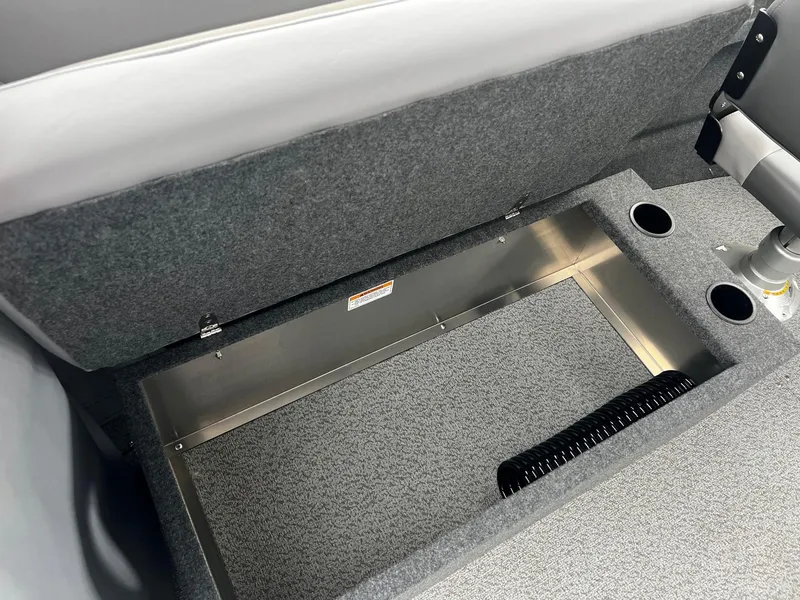 Slide: The Image of 2024 Thunder Jet 200 Luxor under-seat storage compartment with cup holders. - 13