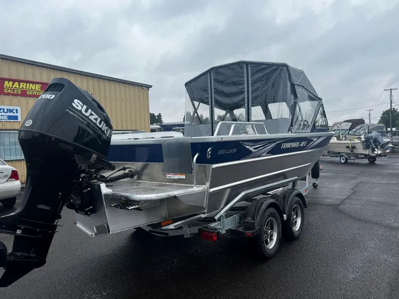 Slide: The Image of 2024 Thunder Jet 200 Luxor boat with Suzuki outboard motor in a marine sales lot. - 3