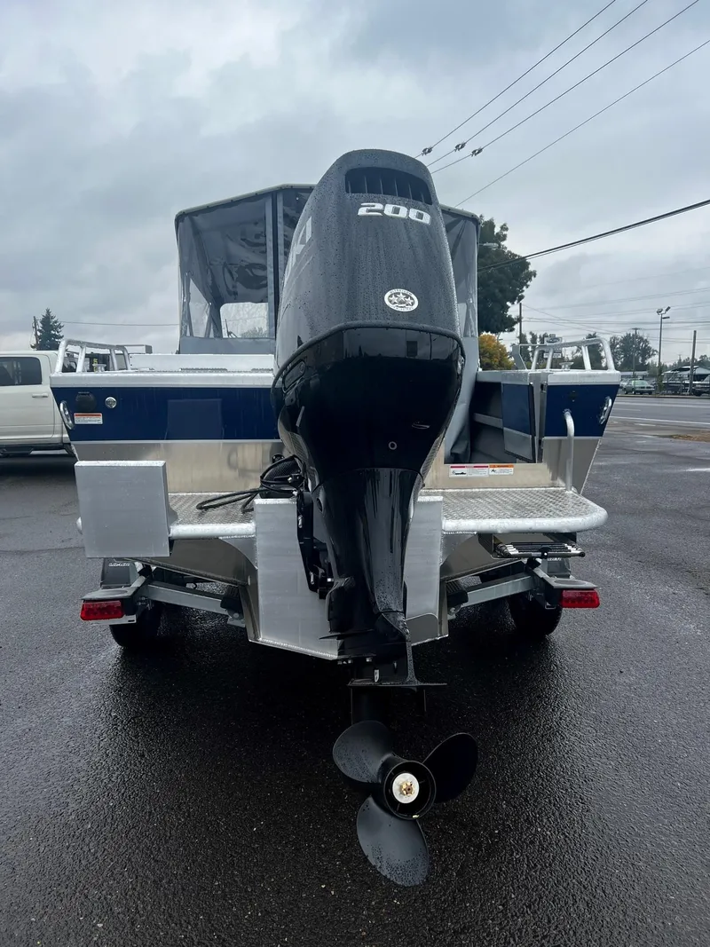 Slide: The Image of 2024 Thunder Jet 200 Luxor boat with outboard motor, rear view on wet pavement. - 4