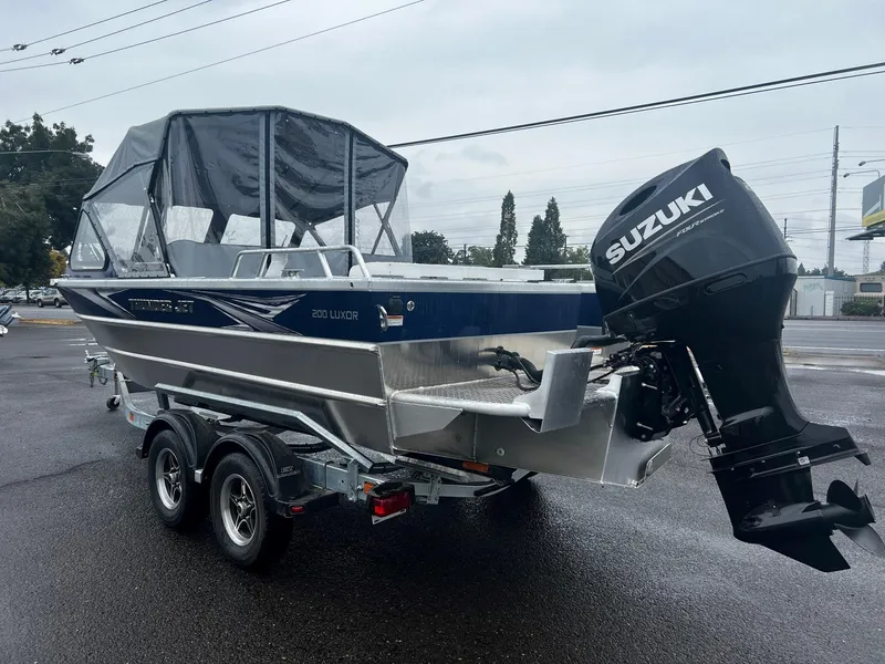 Slide: The Image of 2024 Thunder Jet 200 Luxor boat with Suzuki outboard motor on trailer. - 5