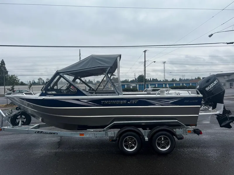 Slide: The Image of 2024 Thunder Jet 200 Luxor boat on trailer with Suzuki outboard motor. - 6