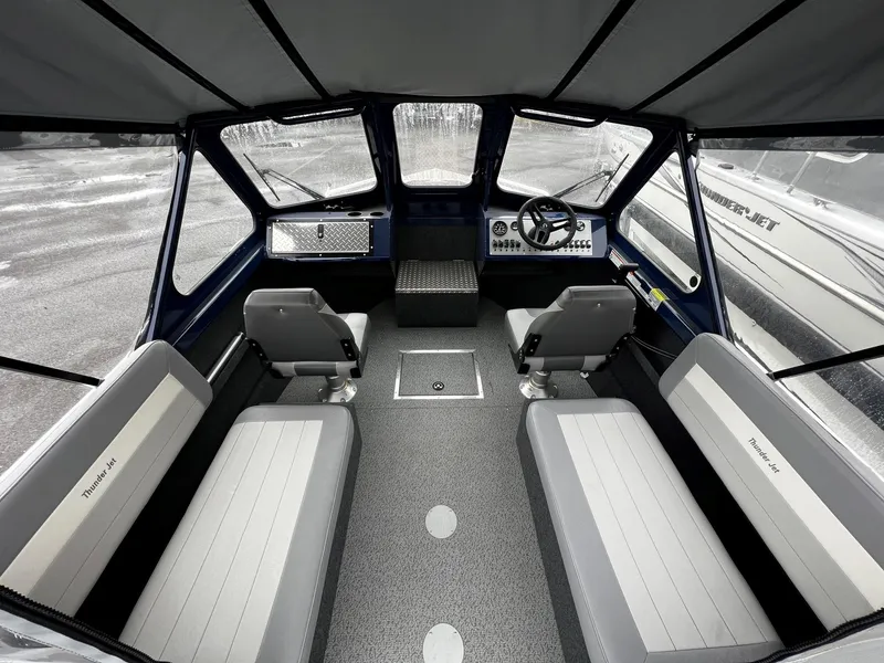 Slide: The Image of Interior of 2024 Thunder Jet 200 Luxor boat with seating and steering console. - 9