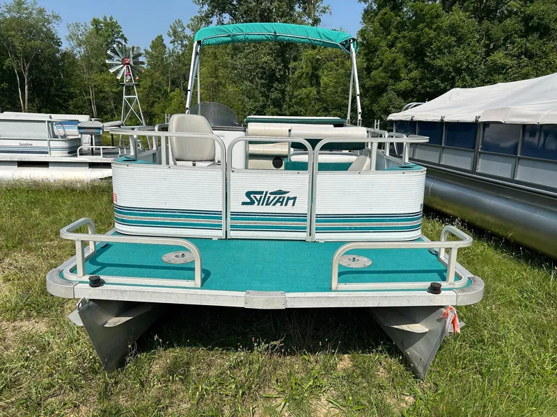 Slide: The Image of 1994 Sylvan Advantage 20 pontoon boat with green carpet and canopy. - 1