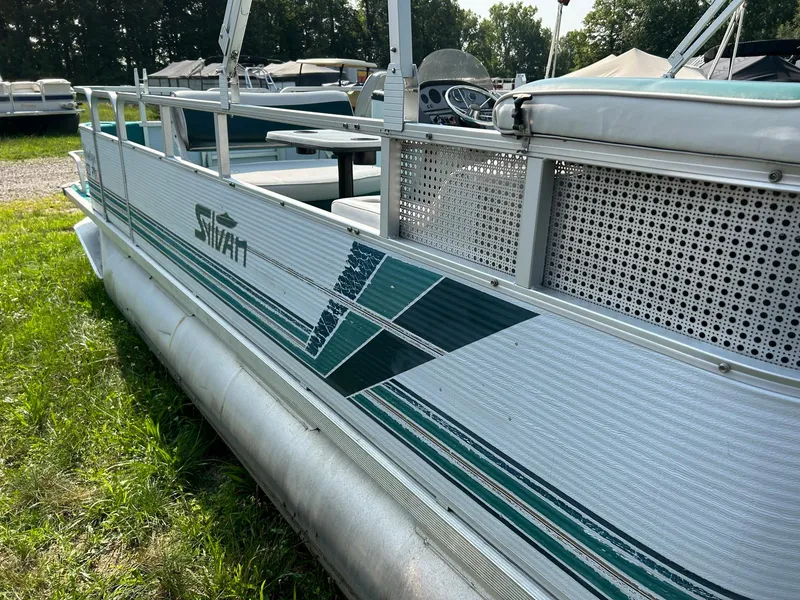 Slide: The Image of 1994 Sylvan Advantage 20 pontoon boat with green and white design. - 2