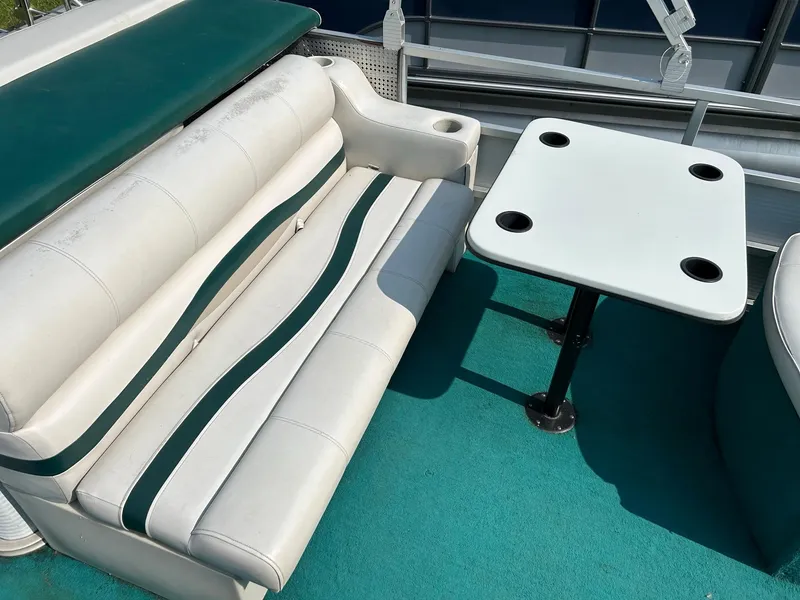 Slide: The Image of 1994 Sylvan Advantage 20 boat interior with white seating and table. - 7