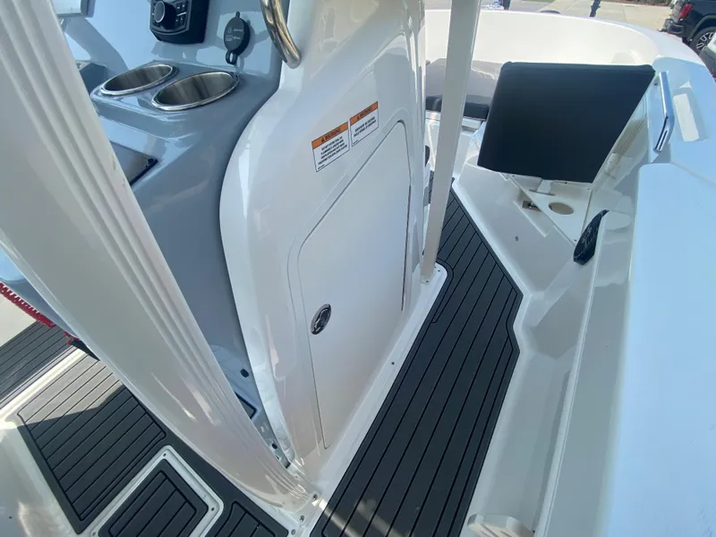 Slide: The Image of 2024 Bayliner Trophy 20 CC center console interior with cup holders and storage. - 20