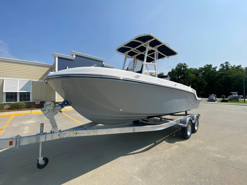 Slide: The Image of 2024 Bayliner Trophy 20 CC boat on a trailer in a parking lot. - 4