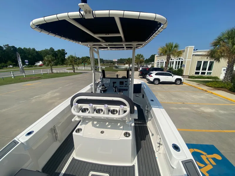 Slide: The Image of 2024 Bayliner Trophy 20 CC center console boat in a parking lot. - 5