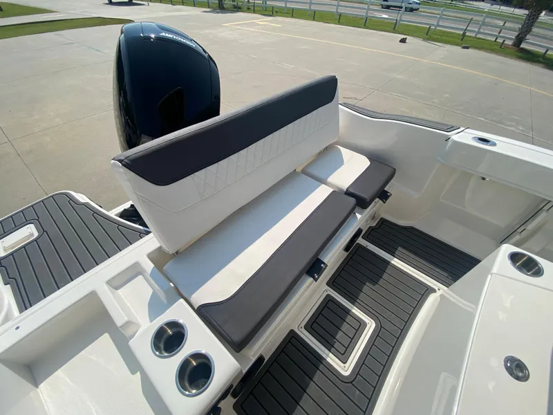 Slide: The Image of 2024 Bayliner Trophy 20 CC boat interior with cushioned seating and cup holders. - 7