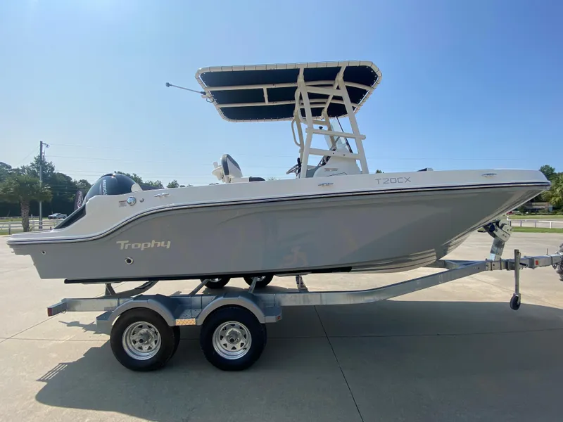 Slide: The Image of 2024 Bayliner Trophy 20 CC boat on a trailer, side view. - 0
