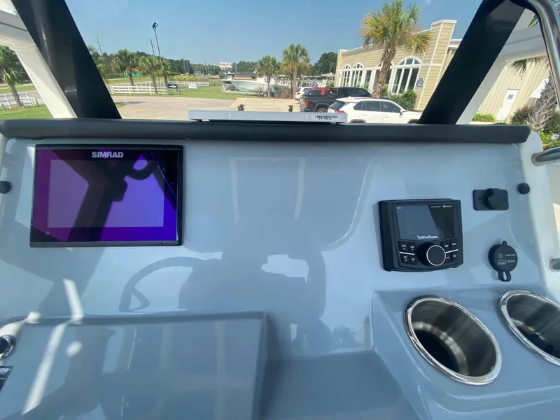Slide: The Image of 2024 Bayliner Trophy 20 CC dashboard with Simrad display and control panel. - 13