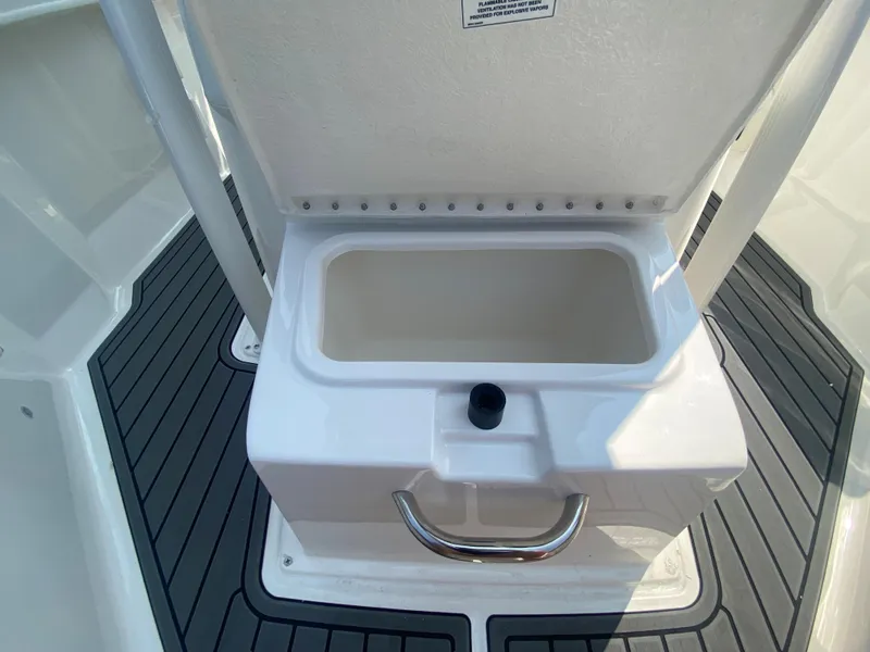 Slide: The Image of 2024 Bayliner Trophy 20 CC boat storage compartment with handle. - 16