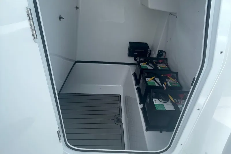 Slide: The Image of 2021 Sportsman Masters 267OE Bay Boat storage compartment with organized battery setup. - 10