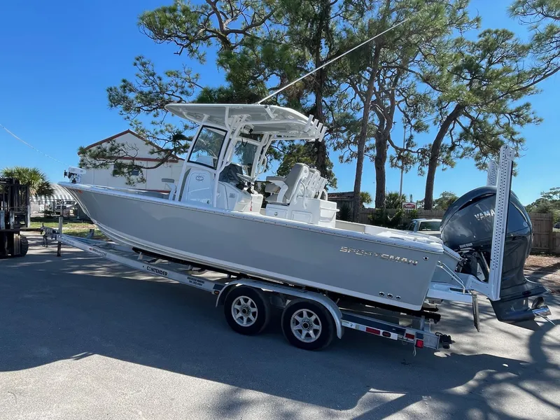 Slide: The Image of 2021 Sportsman Masters 267OE Bay Boat on trailer in outdoor setting. - 13