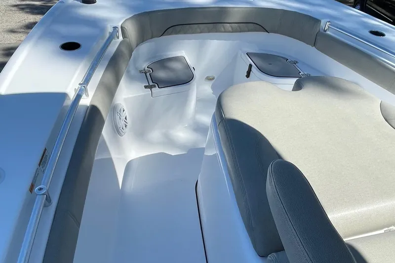 Slide: The Image of 2021 Sportsman Masters 267OE Bay Boat interior with cushioned seating and storage compartments. - 19