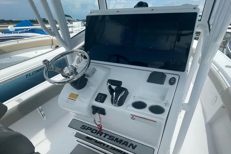Slide: The Image of 2021 Sportsman Masters 267OE Bay Boat helm with steering wheel and control panel. - 4
