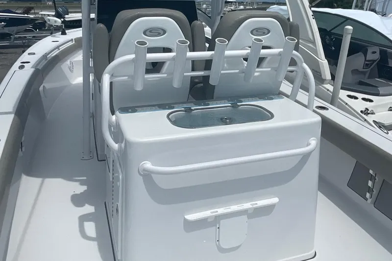 Slide: The Image of 2021 Sportsman Masters 267OE Bay Boat interior with rod holders and seating. - 7