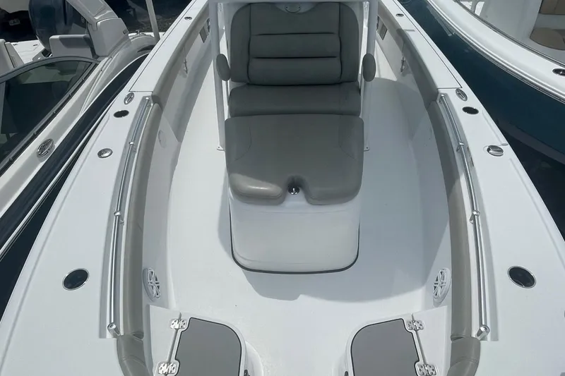 Slide: The Image of 2021 Sportsman Masters 267OE Bay Boat with cushioned seating and storage compartments. - 8