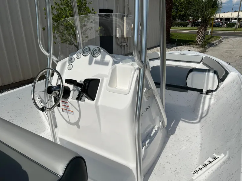 Slide: The Image of 2024 ALK2 Powerboats 22 CRS center console boat with steering wheel and gauges. - 22