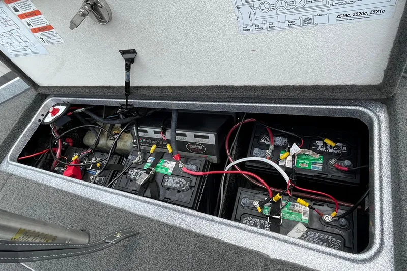 Slide: The Image of 2016 Ranger Z520C boat battery compartment with multiple batteries and wiring. - 13