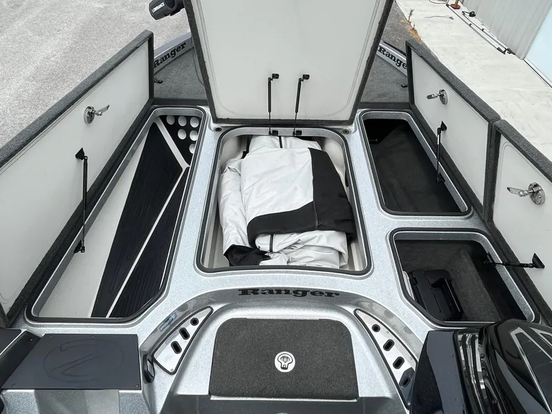Slide: The Image of 2016 Ranger Z520C boat storage compartments with open hatches and gear. - 6