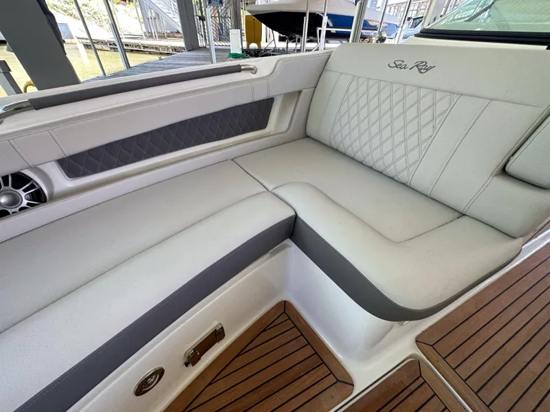 Slide: The Image of 2023 Sea Ray SLX 310 OB boat interior with luxurious seating and teak flooring. - 15