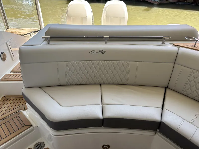 Slide: The Image of 2023 Sea Ray SLX 310 OB boat with luxurious seating and dual outboard motors. - 3