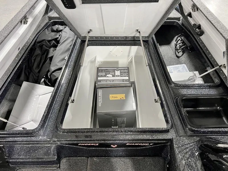 Slide: The Image of 2024 Phoenix 920 Elite boat storage compartments with gear and equipment. - 10