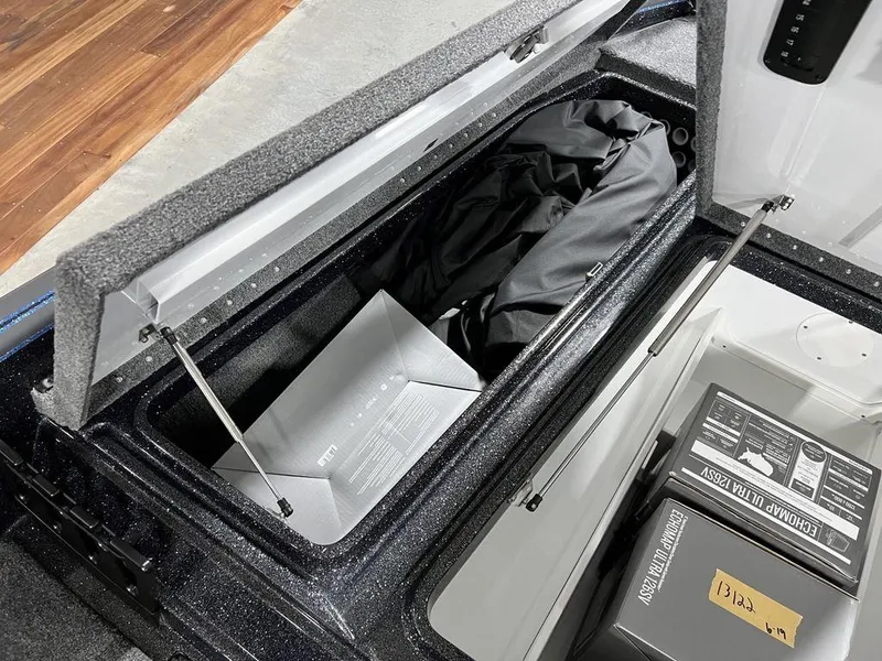Slide: The Image of Storage compartment of 2024 Phoenix 920 Elite boat with gear and equipment. - 13