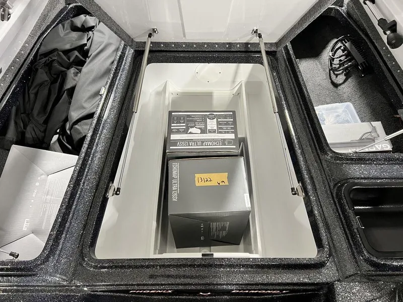 Slide: The Image of 2024 Phoenix 920 Elite storage compartment with boxes and accessories. - 14