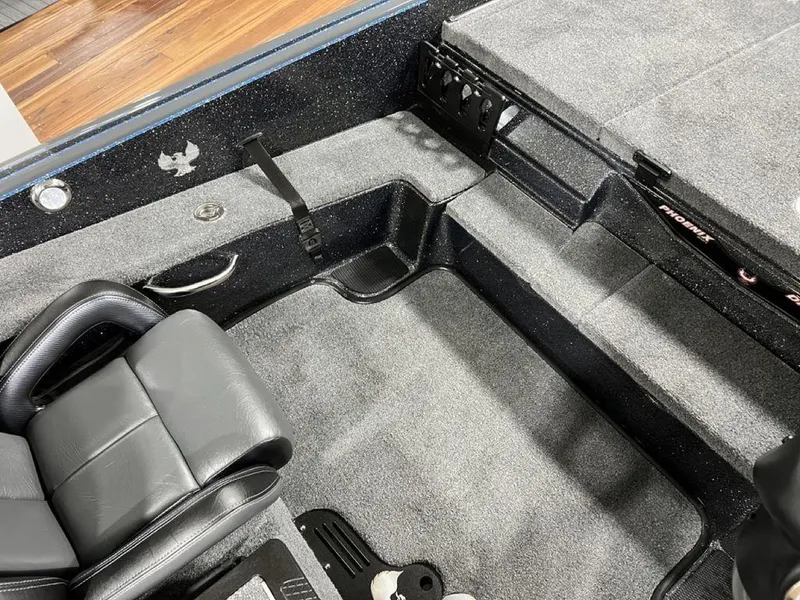 Slide: The Image of 2024 Phoenix 920 Elite boat interior with gray carpet and seating. - 16