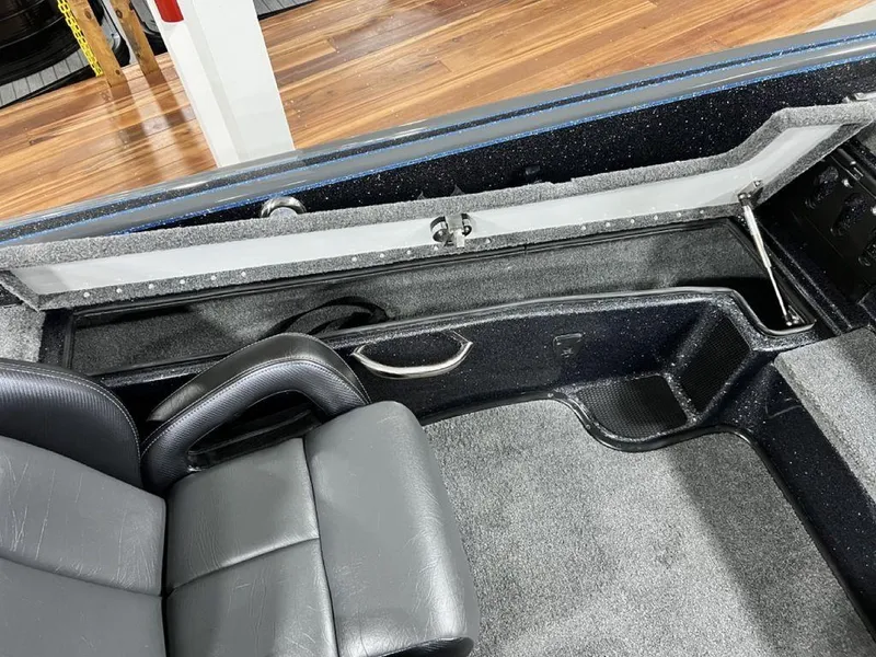 Slide: The Image of 2024 Phoenix 920 Elite boat interior with black leather seats and storage compartments. - 17