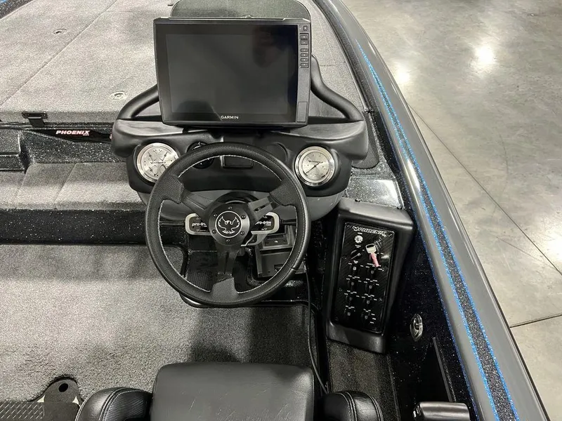 Slide: The Image of 2024 Phoenix 920 Elite boat dashboard with steering wheel and electronic display. - 21