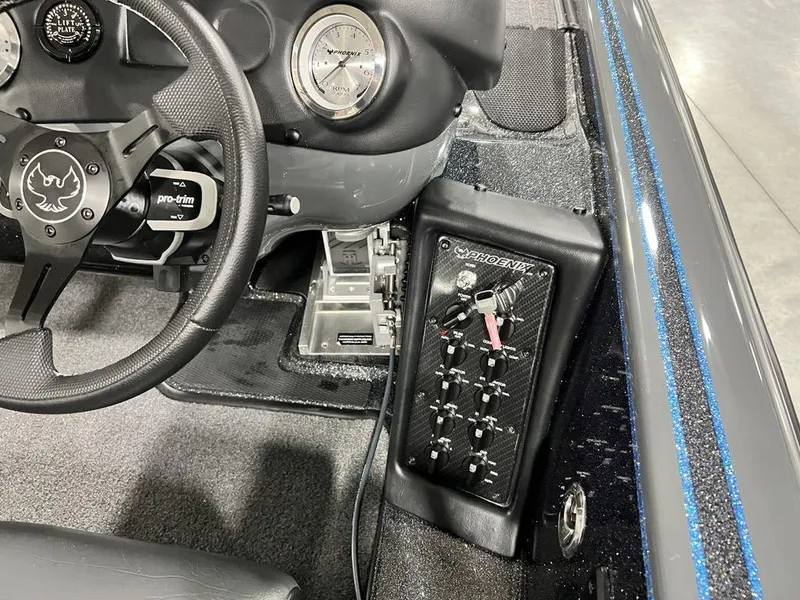 Slide: The Image of 2024 Phoenix 920 Elite boat dashboard with steering wheel and control panel. - 22