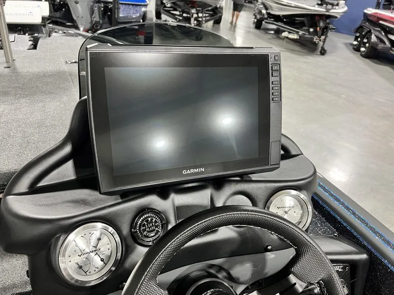 Slide: The Image of 2024 Phoenix 920 Elite boat dashboard with Garmin display and gauges. - 23