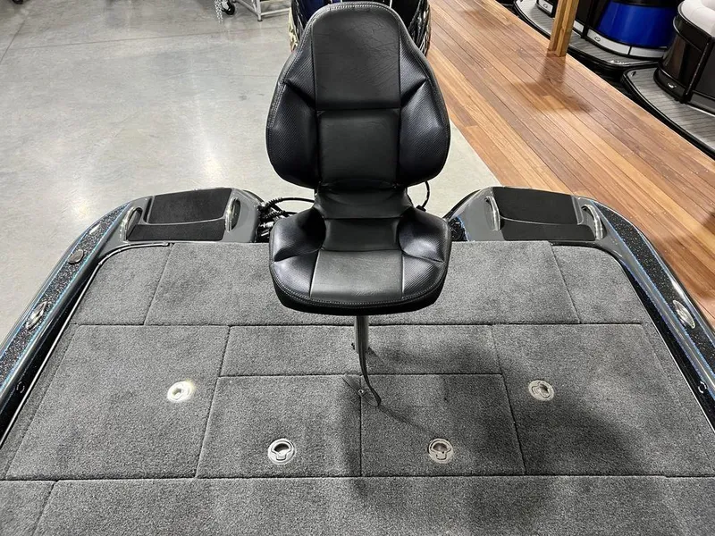 Slide: The Image of 2024 Phoenix 920 Elite boat with a black captain's chair on a gray deck. - 24