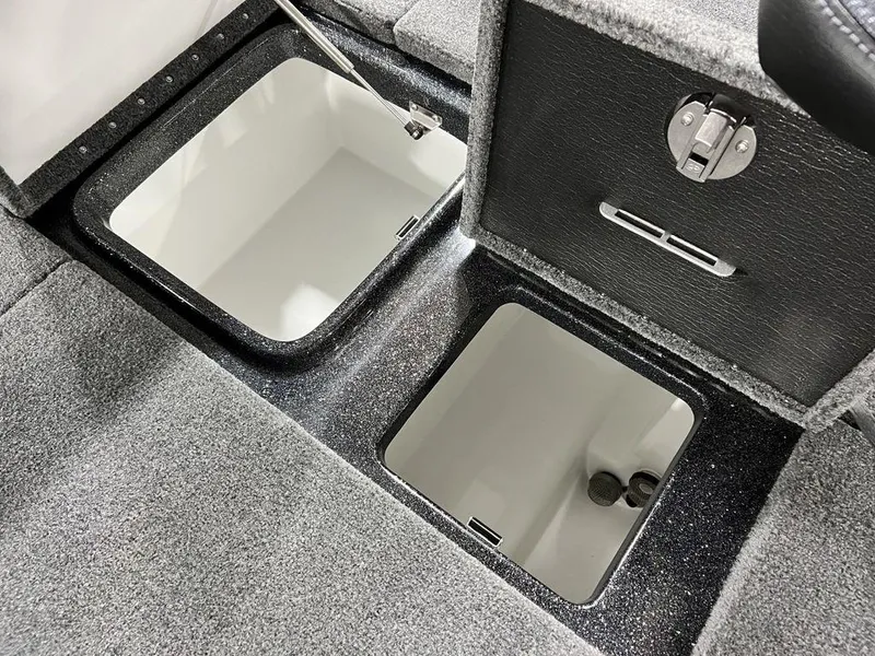 Slide: The Image of 2024 Phoenix 920 Elite boat storage compartments with open lids. - 25