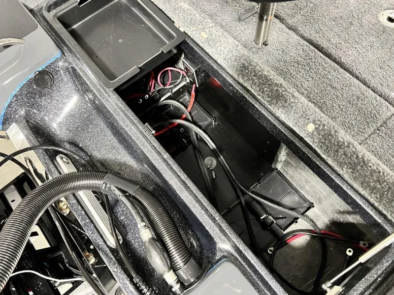 Slide: The Image of 2024 Phoenix 920 Elite boat interior wiring and storage compartment. - 27