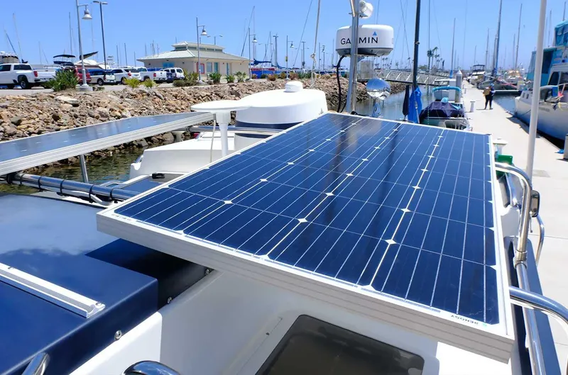 Slide: The Image of 2014 Ranger Tugs R-25 SC with solar panels docked at a marina. - 3