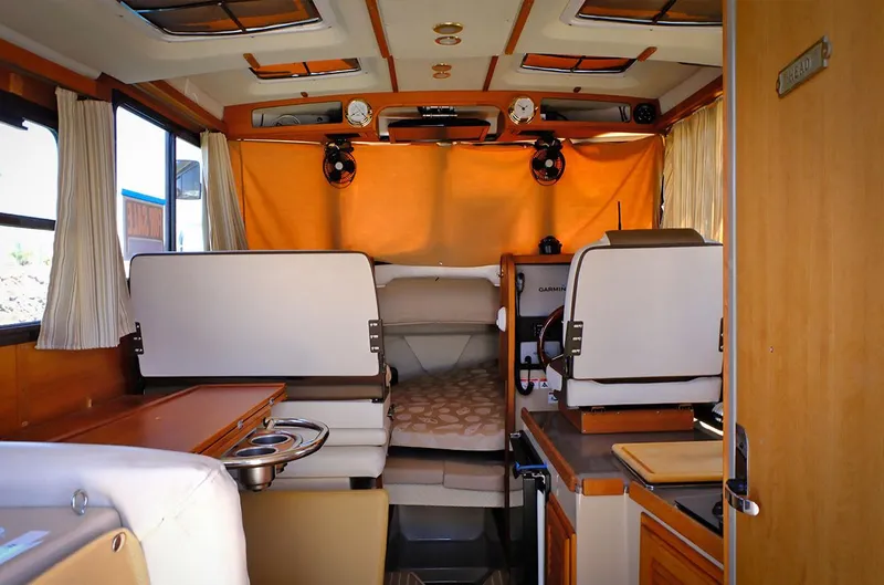 Slide: The Image of 2014 Ranger Tugs R-25 SC interior cabin with seating and sleeping area. - 6