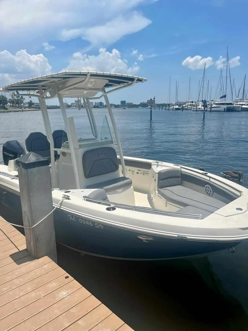 Slide: The Image of 2020 Stingray 216 CC boat docked at marina on a sunny day. - 0