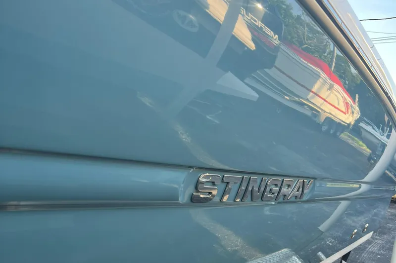 Slide: The Image of 2020 Stingray 216 CC boat side view with logo. - 12